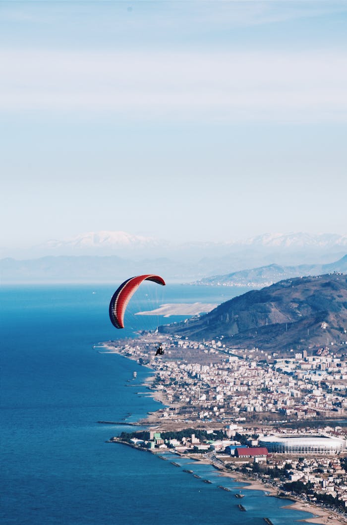 Scenic aerial view of a paraglider soaring over the stunning Boztepe coastline in Ordu, Turkey.