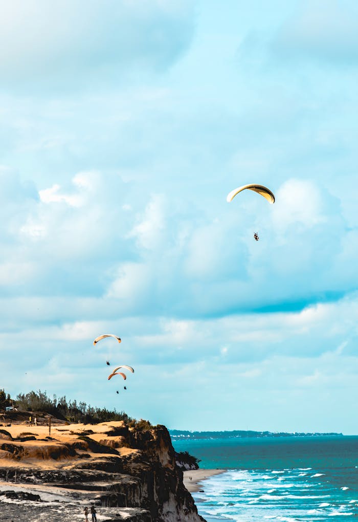 Exciting paragliding over cliffs at Pipa Beach, Brazil, with stunning ocean views.